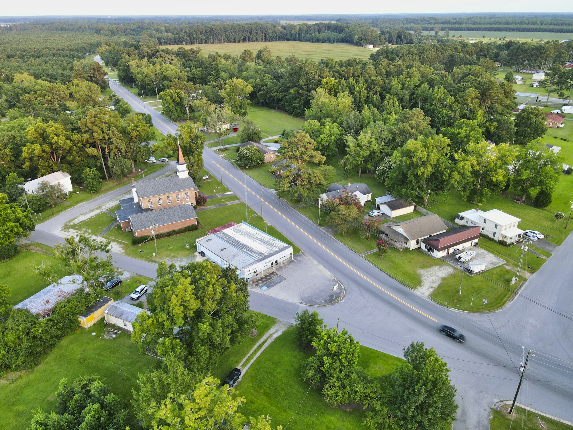 A small town seen from above — homes, trees, and Main Street together